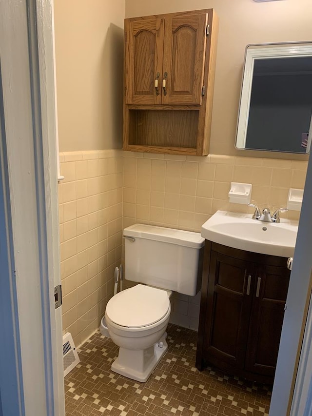 1109 Sumter St, Dothan, AL 36301 - bathroom with tile walls, vanity, tile patterned flooring, and a wainscoted wall
