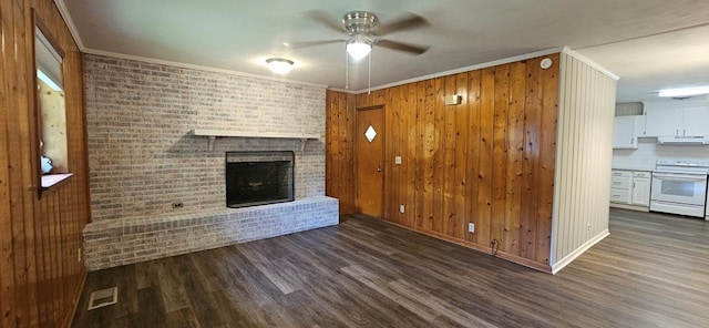 1109 Sumter St, Dothan, AL 36301 - unfurnished living room with ceiling fan, wood finished floors, a fireplace, crown molding, and wooden walls