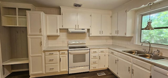 1109 Sumter St, Dothan, AL 36301 - kitchen featuring white electric stove, exhaust hood, backsplash, and light countertops