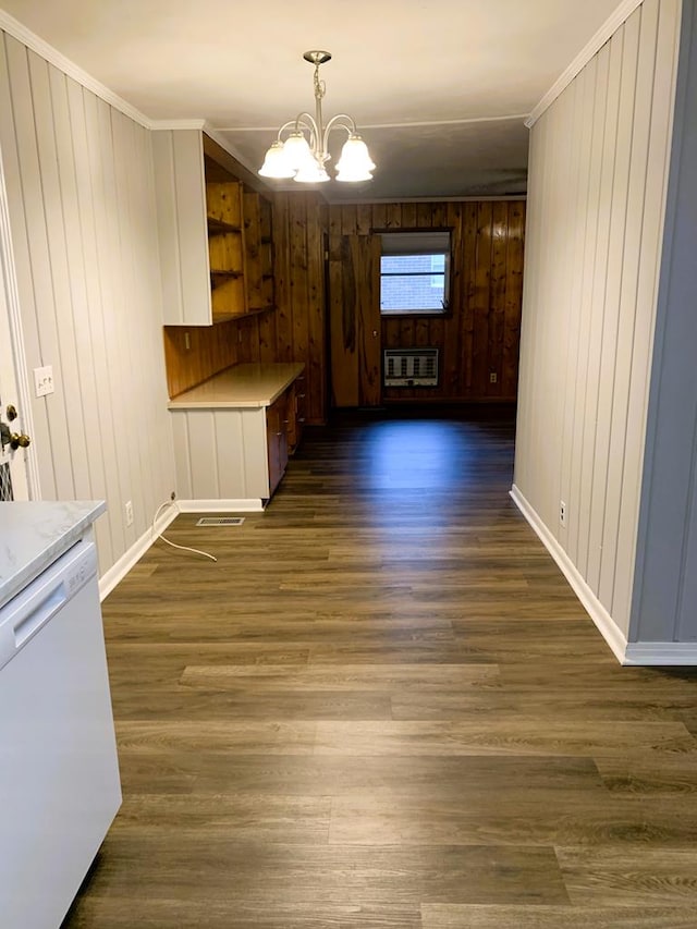 1109 Sumter St, Dothan, AL 36301 - unfurnished dining area with a chandelier, wooden walls, dark wood-style floors, crown molding, and heating unit