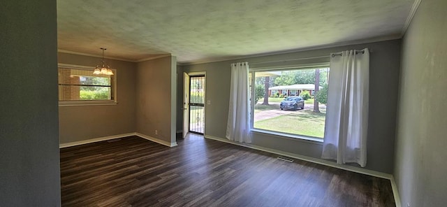 1109 Sumter St, Dothan, AL 36301 - spare room featuring a chandelier, dark wood-type flooring, and crown molding