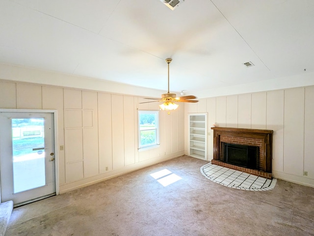 602 Cobb Rd, Dothan, AL 36301 - unfurnished living room featuring a decorative wall, a fireplace, a ceiling fan, and carpet