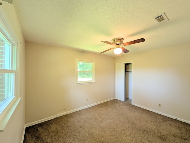 602 Cobb Rd, Dothan, AL 36301 - unfurnished bedroom featuring carpet flooring, a closet, a textured ceiling, and ceiling fan