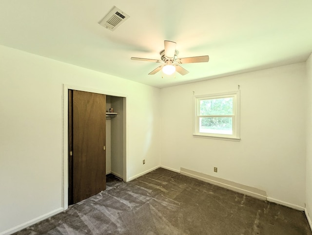 602 Cobb Rd, Dothan, AL 36301 - unfurnished bedroom featuring dark carpet, a closet, and a ceiling fan