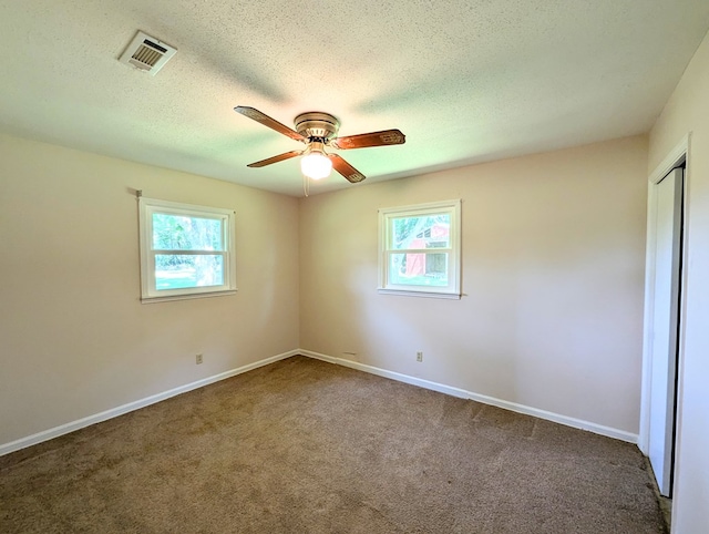 602 Cobb Rd, Dothan, AL 36301 - empty room with healthy amount of natural light, a ceiling fan, carpet flooring, and a textured ceiling