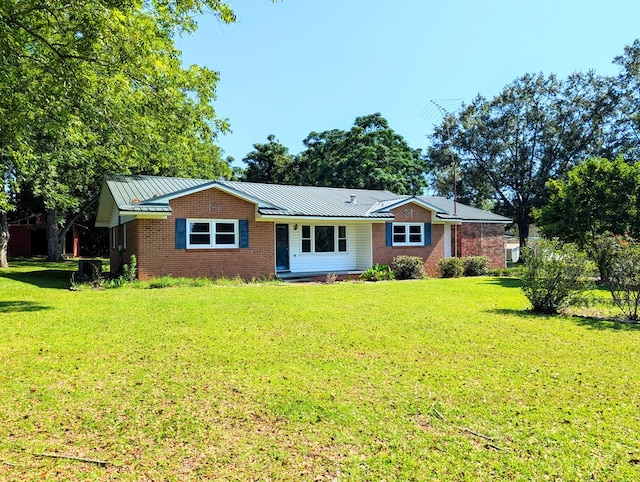 602 Cobb Rd, Dothan, AL 36301 - ranch-style house with brick siding, a front yard, and a metal roof