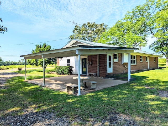 602 Cobb Rd, Dothan, AL 36301 - view of front facade featuring brick siding, a front lawn, a patio area, and an attached carport