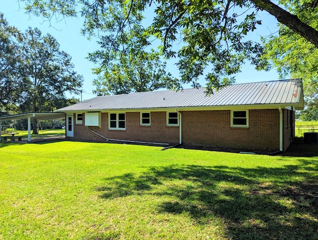 602 Cobb Rd, Dothan, AL 36301 - rear view of house featuring a yard, a metal roof, and brick siding
