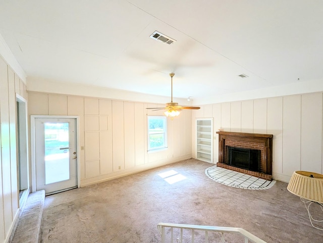 602 Cobb Rd, Dothan, AL 36301 - unfurnished living room with a decorative wall, a brick fireplace, and a ceiling fan