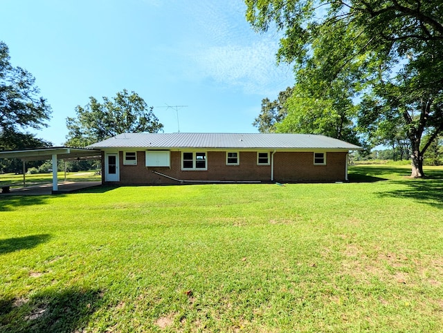 602 Cobb Rd, Dothan, AL 36301 - back of property featuring brick siding, a yard, and a metal roof