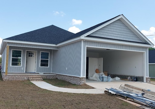 273 County Road 60, Slocomb, AL 36375 - view of front facade featuring a shingled roof, a porch, and an attached garage