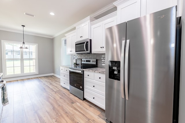 kitchen with appliances with stainless steel finishes, light wood-type flooring, light stone counters, decorative light fixtures, and white cabinets