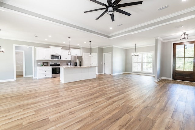 unfurnished living room with ceiling fan with notable chandelier, light hardwood / wood-style floors, and ornamental molding