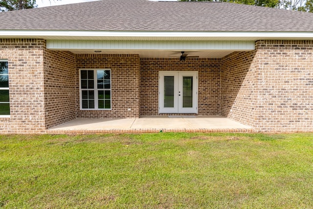 back of house featuring a lawn, ceiling fan, french doors, and a patio