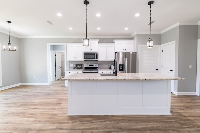 kitchen with a kitchen island with sink, light hardwood / wood-style flooring, decorative light fixtures, white cabinetry, and stainless steel appliances