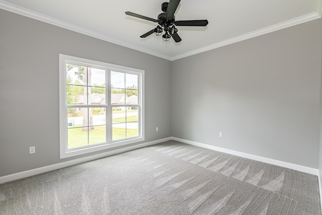 carpeted spare room featuring ceiling fan, crown molding, and a wealth of natural light