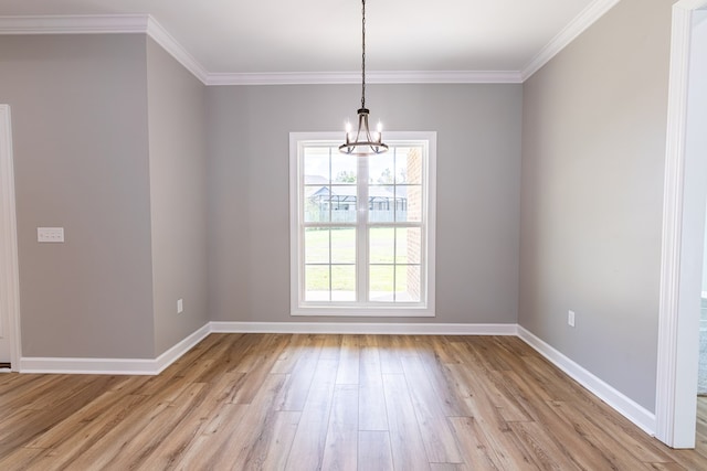 unfurnished dining area featuring a chandelier, light hardwood / wood-style floors, and ornamental molding