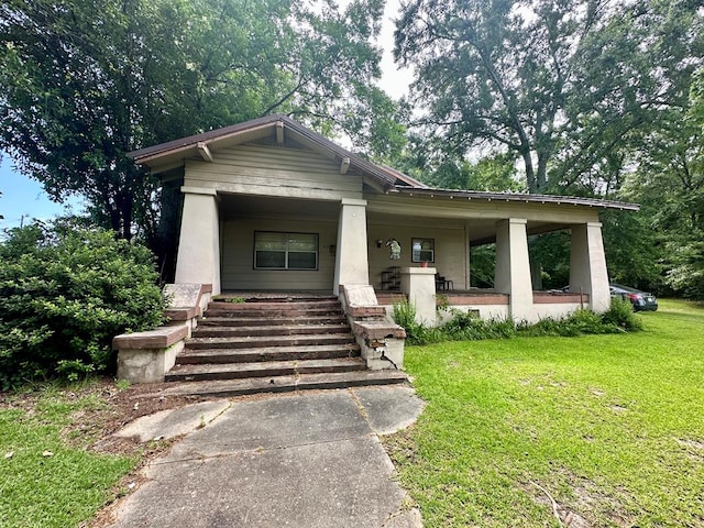 view of front of home featuring covered porch and a front lawn