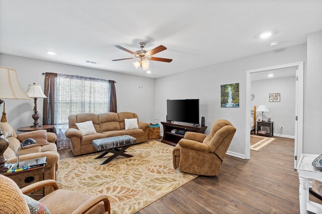 living room with wood-type flooring and ceiling fan