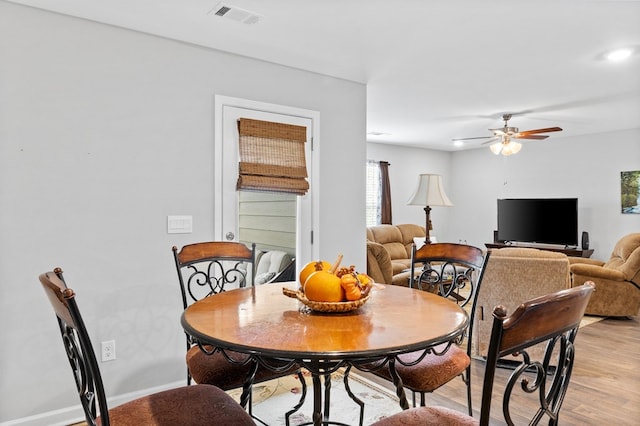 dining room featuring ceiling fan and light hardwood / wood-style flooring