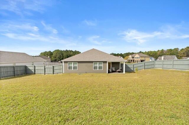 rear view of house with a yard