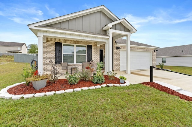 craftsman-style home featuring a front yard, a garage, and covered porch