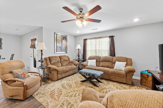 living room with hardwood / wood-style flooring and ceiling fan