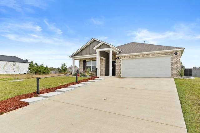 craftsman house featuring a garage, a front lawn, and central air condition unit