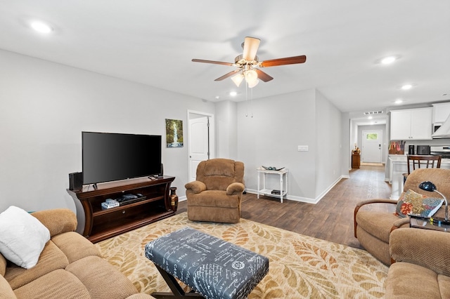 living room featuring ceiling fan and hardwood / wood-style flooring