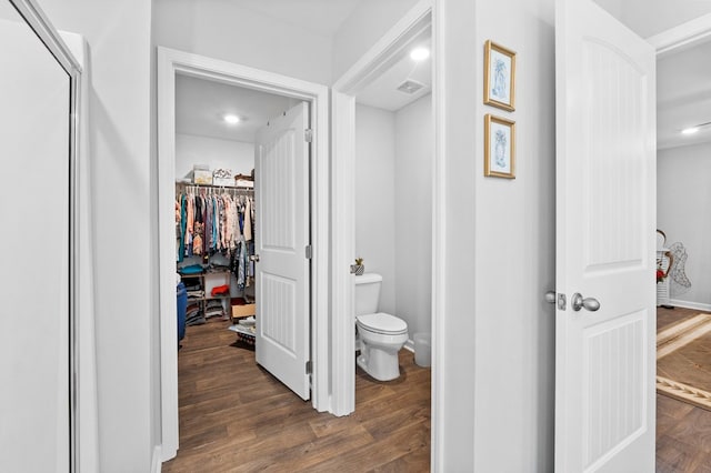 bathroom with toilet and wood-type flooring