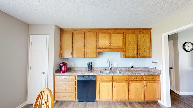 284 Alec Cir, Ozark, AL 36360 - kitchen featuring dishwasher, a sink, wood finished floors, brown cabinetry, and a textured ceiling