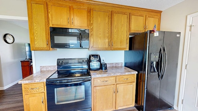 284 Alec Cir, Ozark, AL 36360 - kitchen with black appliances, light countertops, dark wood finished floors, baseboards, and brown cabinetry