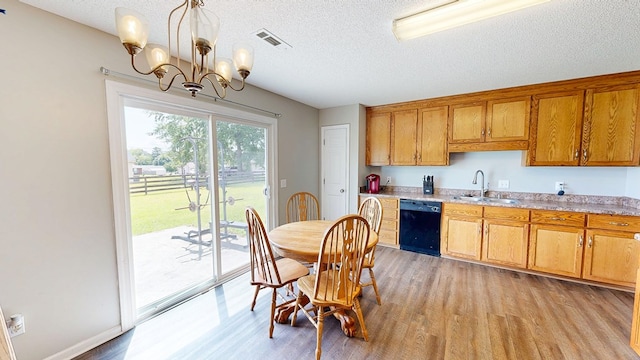 284 Alec Cir, Ozark, AL 36360 - kitchen featuring black dishwasher, a sink, light wood-type flooring, a chandelier, and a textured ceiling