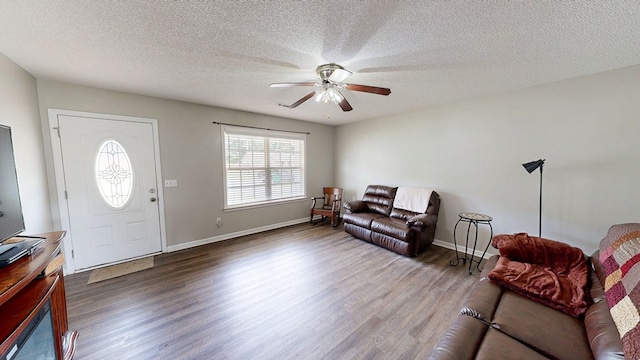 284 Alec Cir, Ozark, AL 36360 - living room with dark wood-style floors, ceiling fan, a textured ceiling, and baseboards