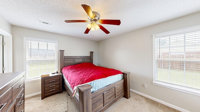 284 Alec Cir, Ozark, AL 36360 - bedroom with light carpet, a textured ceiling, ceiling fan, and baseboards