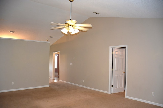 carpeted empty room with visible vents, lofted ceiling, and baseboards