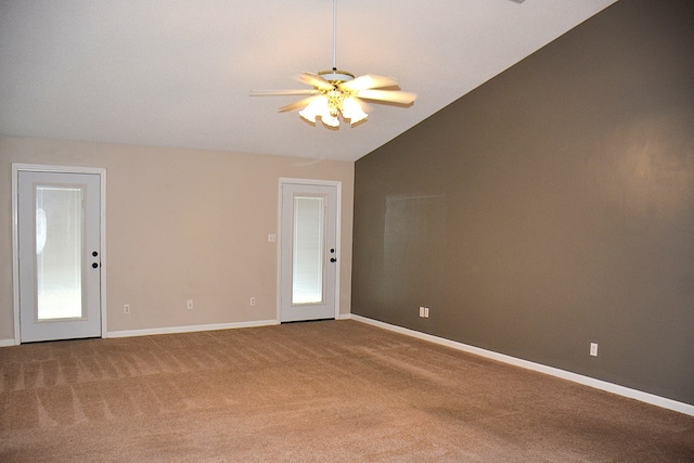 empty room with baseboards, carpet, ceiling fan, and vaulted ceiling