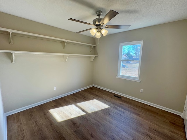 spare room with ceiling fan, dark hardwood / wood-style floors, and a textured ceiling