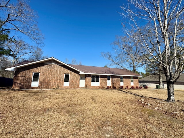 rear view of house with a yard