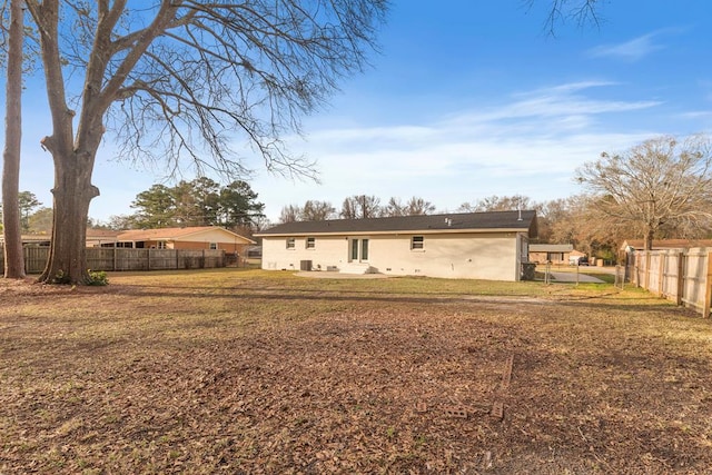 rear view of property featuring a yard