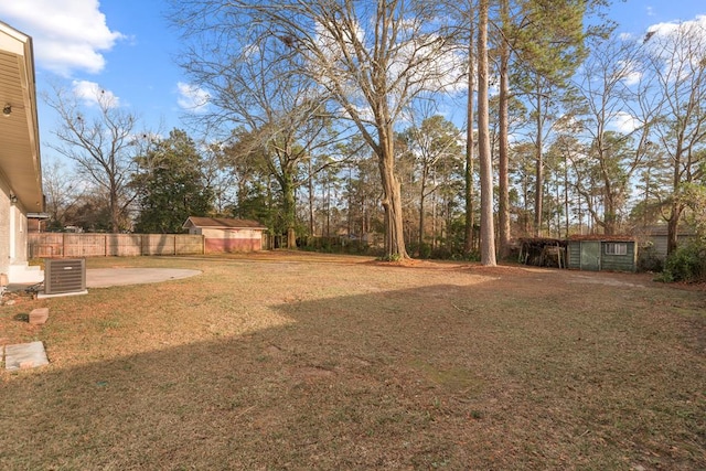 view of yard with a patio, a shed, and central air condition unit