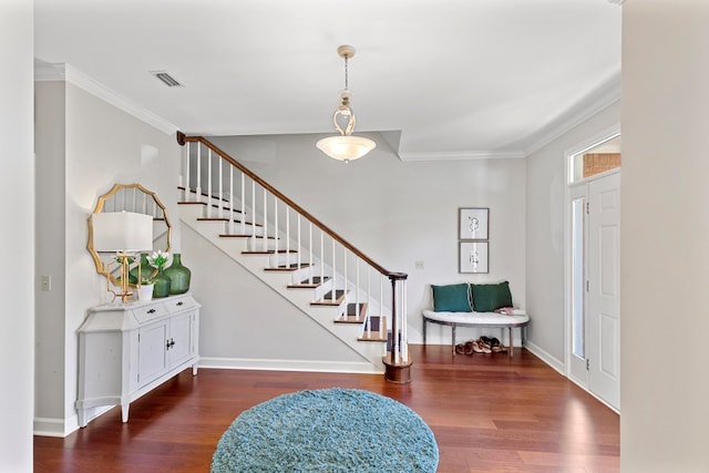 foyer entrance featuring dark hardwood / wood-style flooring and crown molding