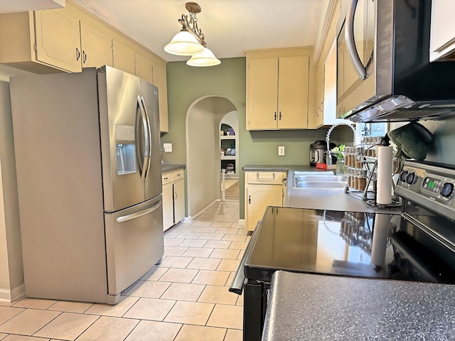 kitchen with hanging light fixtures, appliances with stainless steel finishes, sink, and light tile patterned flooring