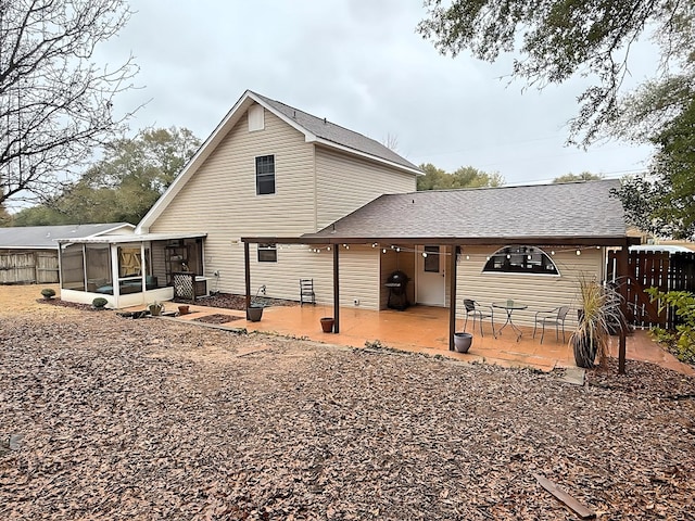 back of property with a patio area and a sunroom