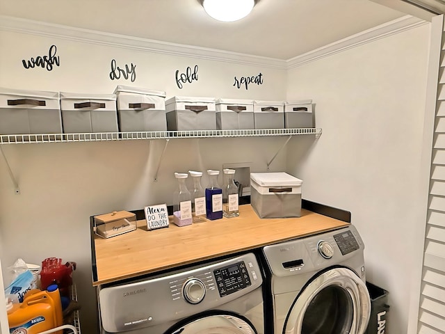 washroom with washer and dryer and crown molding