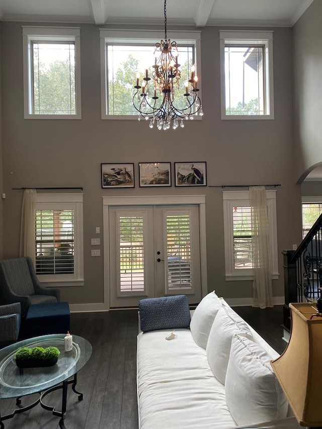 living room with a chandelier, plenty of natural light, and dark wood-type flooring