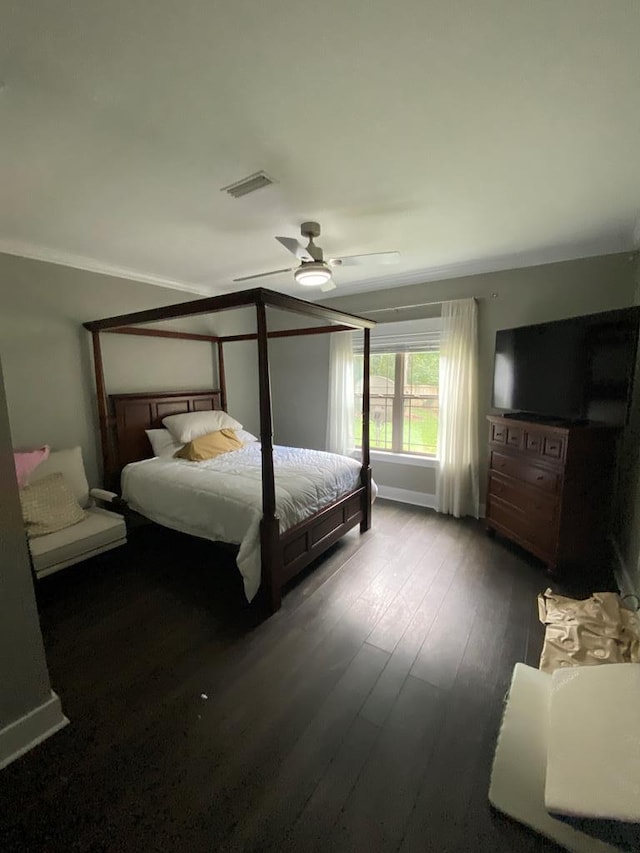 bedroom featuring hardwood / wood-style flooring, ceiling fan, and crown molding