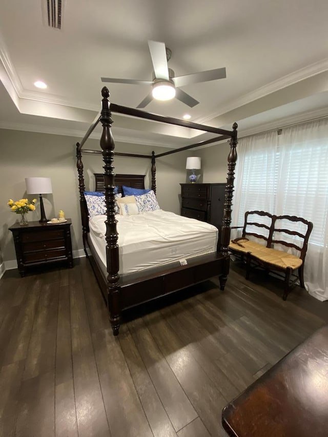 bedroom featuring ceiling fan, crown molding, and dark wood-type flooring