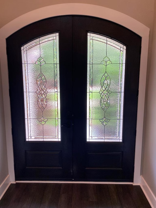 foyer with dark hardwood / wood-style flooring and french doors