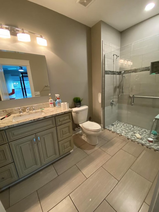 bathroom with vanity, toilet, and walk in shower